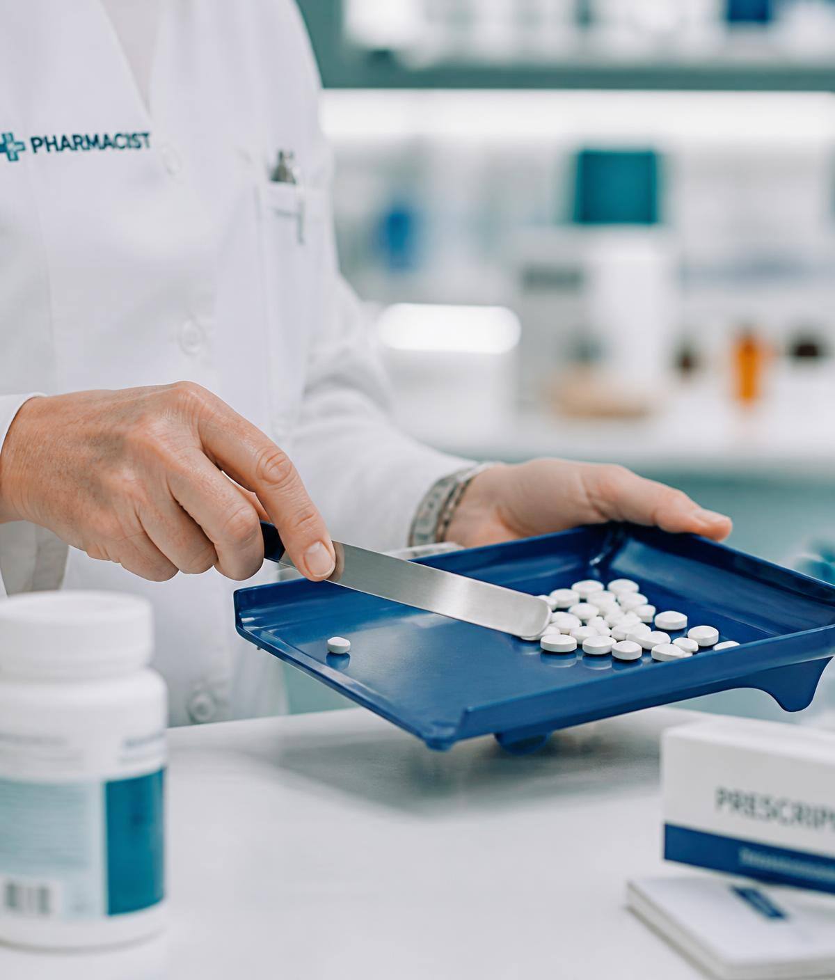 Pharmacist preparing medication at the dispensary bench